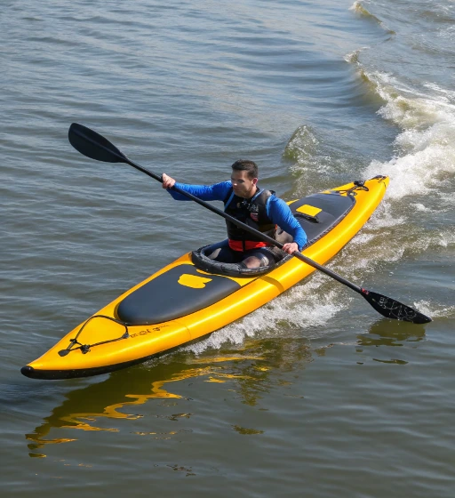 Paddler in a narrow inflatable kayak cutting through small waves, demonstrating hull shape and water interaction affecting inflatable kayak performance

