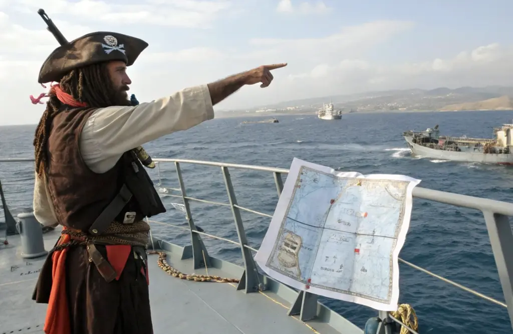 Pirate directing vessel movement with map on deck near coastline, illustrating holding strategy and territorial control in Red Sea shipping attacks news today and piracy risk operations
