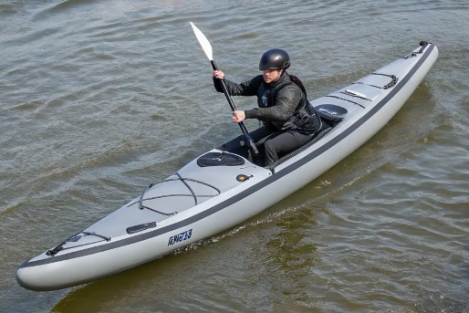 Paddler in a long, narrow inflatable kayak on calm water, illustrating flatwater hull design and tracking performance in inflatable kayaks
