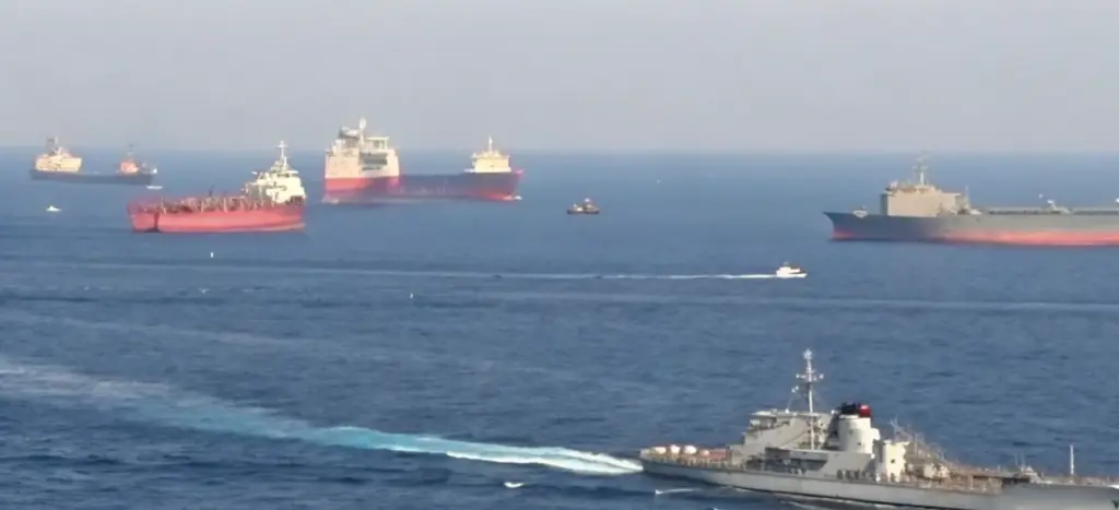 Multiple cargo ships and naval vessels moving through congested sea lanes, illustrating strategic context in Red Sea shipping attacks news today and shifting piracy risk across routes
